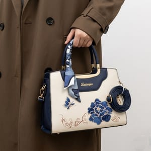 Embroidered Floral & Butterfly Top-Handle Bag with Decorative Scarf and Gold Hardware.