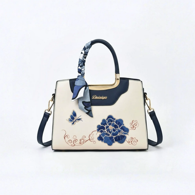 Embroidered Floral & Butterfly Top-Handle Bag with Decorative Scarf and Gold Hardware.